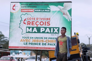 A pedestrian passes one of The United Methodist Church’s billboards calling for peace in the community of Abobo, Côte d’Ivoire. The United Methodist Church and its partners organized a communication campaign asking that the population and the authorities show restraint during the electoral period. The caravan crisscrossed several towns and hamlets in Côte d’Ivoire. Photo by Isaac Broune, UM News. A pedestrian passes one of The United Methodist Church’s billboards calling for peace in the community of Abobo, Côte d’Ivoire. The United Methodist Church and its partners organized a communication campaign asking that the population and the authorities show restraint during the electoral period. The caravan crisscrossed several towns and hamlets in Côte d’Ivoire. Photo by Isaac Broune, UM News.