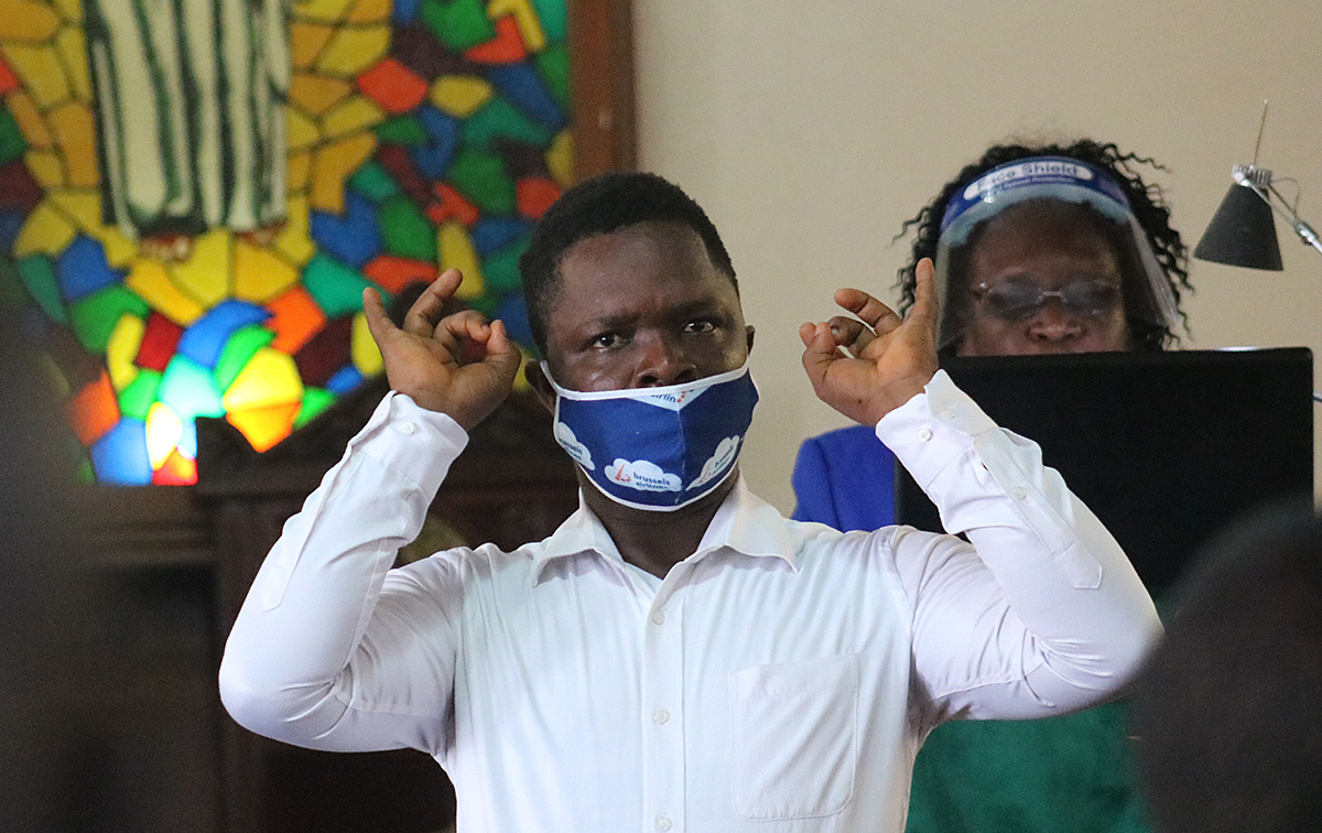 Interpreter Victor Fahn signs the message of Esther Metzgar during a Sunday morning service at S.T. Nagbe United Methodist Church in Monrovia, Liberia. Photo by E Julu Swen, UM News.  