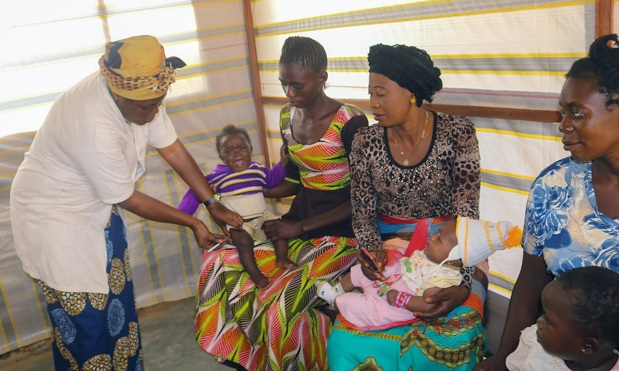 Régine Owanga Kambolo, director of maternity at the Lokolé United Methodist Hospital, vaccinates children during a routine immunization session in Kindu, Congo. The United Methodist Church has medical facilities in remote areas and is working with the government to immunize children. Photo by Chadrack Tambwe Londe, UM News.