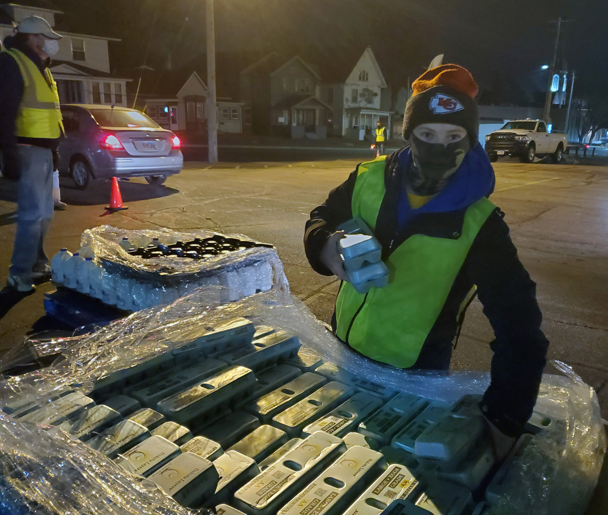 Nathan Jans, bundled up for the cold, assists with a recent food distribution at First United Methodist Church in Sioux Falls, S.D. With economic distress accompanying high COVID-19 numbers in the state, the church has become a partner with the nonprofit Feeding South Dakota. Photo courtesy of the Rev. Sara Nelson.