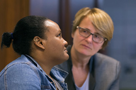 United Methodist deaconess Cindy Johnson (right) walks to buy medicine with Isabél who traveled with her daughter from Nicaragua to Matamoros, Mexico, hoping to request asylum in the U.S. Kassandra, 16 months, was suffering from fever and weight loss while she and her mother waited for their turn to approach the bridge leading to Brownsville, Texas. Johnson, who makes regular visits to the makeshift camp, brought members of the United Methodist Immigration Task Force for a firsthand look at the immigration situation. Photo by Mike DuBose, UMNS.