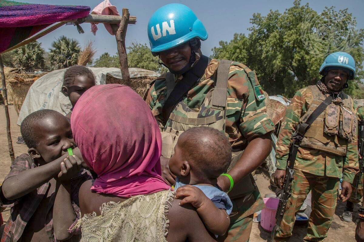 United Nations peacekeepers from Zambia visit with a family while on patrol in the Central African Republic in February, 2020. Following a volatile presidential election there, United Methodists are offering humanitarian aid to people seeking refuge from armed rebels. File photo by Hervé Serefio, United Nations.