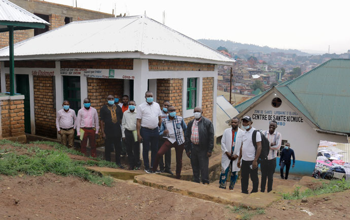 Doctors and nurses stand in front of the isolation and triage room built by Action for the Promotion of Maternal and Child Health, a nongovernmental organization, at United Methodist Irambo Hospital. The staff received training on the hospital's upgraded malaria treatment protocol. Photo By Philippe Kituka Lolonga, UM News.