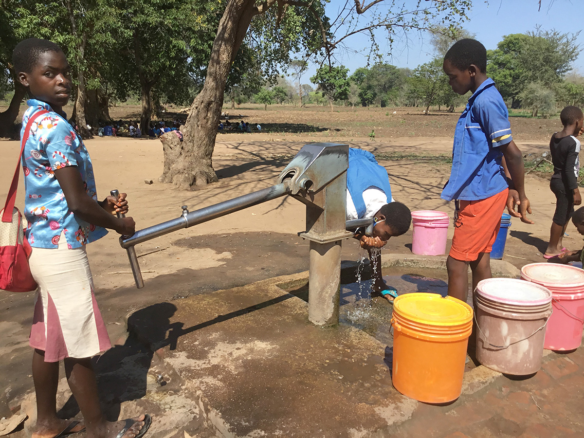 Schoolchildren drink from a borehole at Kalumba Primary School in Mangochi, Malawi, in September 2020. The borehole was drilled by the Malawi government. In response to water scarcity in this east African country, United Methodist Church of the Resurrection in Leawood, Kan., has helped fund the drilling of more than 80 boreholes since September. Photo by Francis Nkhoma, UM News. Schoolchildren drink from a borehole at Kalumba Primary School in Mangochi, Malawi, in September 2020. The borehole was drilled by the Malawi government. In response to water scarcity in this east African country, United Methodist Church of the Resurrection in Leawood, Kan., has helped fund the drilling of more than 80 boreholes since September. Photo by Francis Nkhoma, UM News.