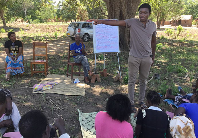 Hugo Ngwira, borehole project coordinator in Malawi for the United Methodist Church of the Resurrection, talks to community members in Chipasi Village about how to maintain a newly drilled borehole. The borehole is one of more than 80 drilled in the past six months with funding from the Kansas City-area church. Photo by Francis Nkhoma, UM News.