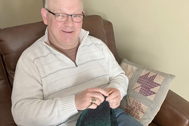 The Rev. Chad Parmalee has found knitting, especially making items for others, a way to relax amid the stresses of pandemic ministry. Parmalee leads Chapel Hill United Methodist Church in Battle Creek, Mich. Photo by Roschenne Parmalee.    The Rev. Chad Parmalee has found knitting, especially making items for others, a way to relax amid the stresses of pandemic ministry. Parmalee leads Chapel Hill United Methodist Church in Battle Creek, Mich. Photo by Roschenne Parmalee.