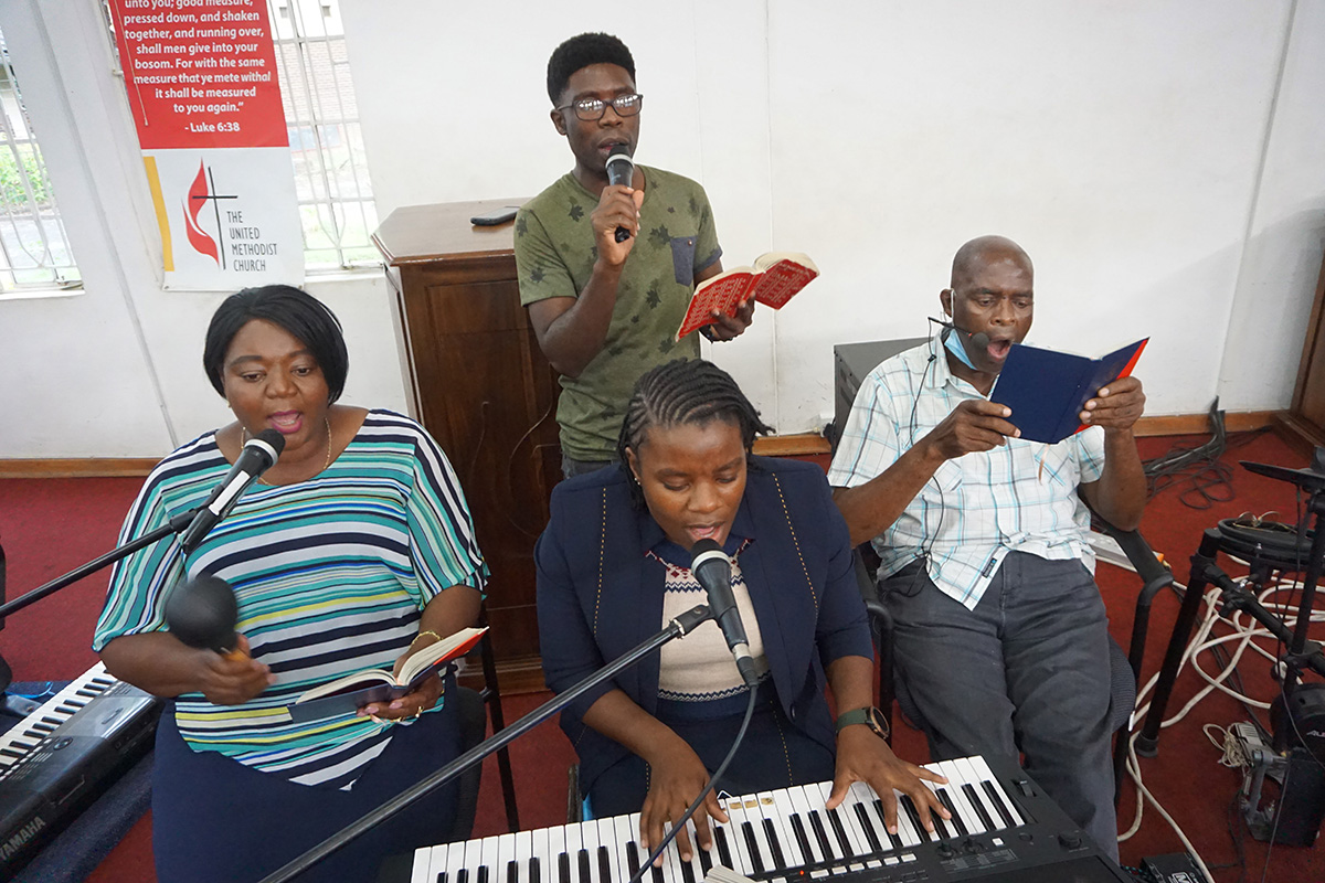 Gospel musicians record a song for an online worship service at Chisipiti United Methodist Church in Harare, Zimbabwe. United Methodists across the country are using music to provide strength and comfort during the pandemic. Seated, from left, are: Patricia Mapani, Christine Anesu Hove and Ricky Mapani. At rear is Ali White. Photo by Kudzai Chingwe, UM News.