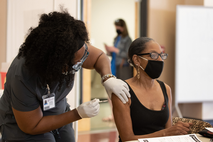 Joyce Holland receives a COVID-19 vaccination from Tia Moore, nurse practitioner, at Meharry Medical College in Nashville, Tenn. Photo by Mike DuBose, UM News.