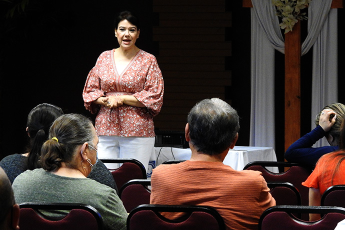 The Rev. Sara Reyes offers greetings to Mexican residents of the Houston area who came to Kingwood United Methodist Church to get Mexican passports renewed or for help with other official documents. Reyes was instrumental in arranging for the Mexican Consulate in Houston to have a team of consular officers working at the church for two weeks earlier this month. Photo by Sam Hodges, UM News.