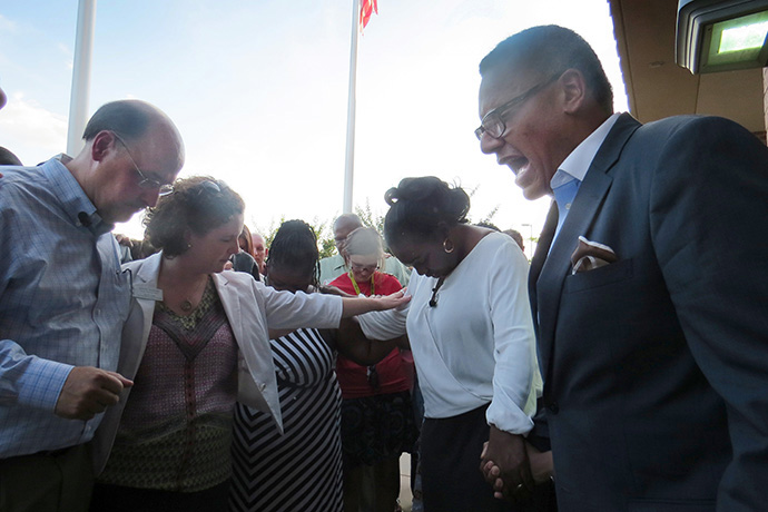 The Rev. Michael L. Bowie leads North Texas Conference clergy and laity in prayer outside the McKinney, Texas, police department in 2015. The group was protesting an officer's treatment of Black youth at a pool party dispute. Bowie, now national director for SBC21, the national racial ethnic plan of The United Methodist Church, is encouraging church members to support former inmates and help them find gainful employment. File photo by Sam Hodges, UM News.