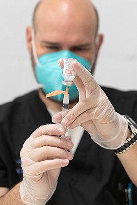 Carl Wood draws a dose of the Moderna COVID-19 vaccine during a clinic at St. Mark’s United Methodist Church in Charlotte, N.C. Wood is president and pharmacy manager of Vax Van by MVS, the company administering the vaccines. Photo by Mike DuBose, UM News.