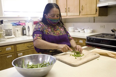 Maria Chavalan Sut prepares a meal for herself in the kitchen at Wesley Memorial United Methodist Church in Charlottesville, Va. After three years of living in sanctuary at the church, Chavalan Sut, who fled Guatemala in 2016, received a Stay of Removal for one year that allows her to move freely until her asylum case is heard. Photo © Richard Lord. Maria Chavalan Sut prepares a meal for herself in the kitchen at Wesley Memorial United Methodist Church in Charlottesville, Va. After three years of living in sanctuary at the church, Chavalan Sut, who fled Guatemala in 2016, received a Stay of Removal for one year that allows her to move freely until her asylum case is heard. Photo © Richard Lord.