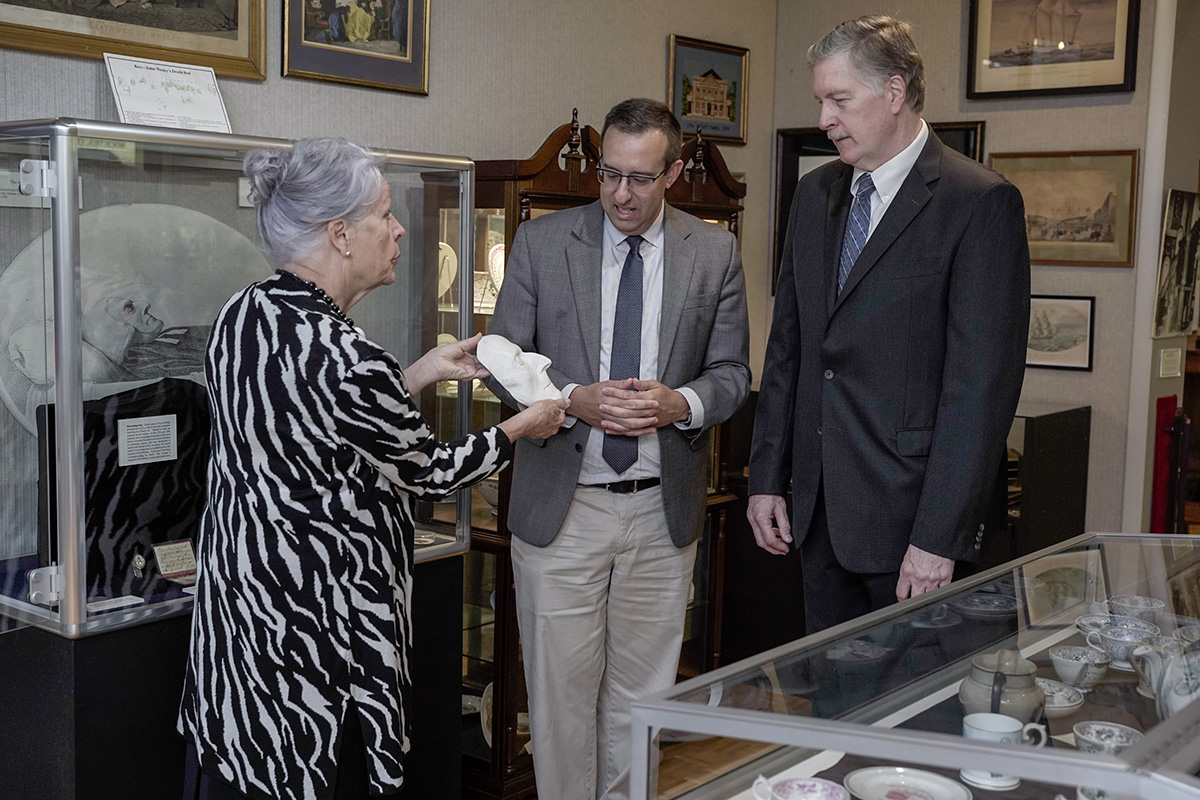 Jackie Bolden (left), director of the World Methodist Museum, shows the John Wesley death mask to Anthony Elia (center), director of Bridwell Library at Perkins School of Theology, and the Rev. Craig C. Hill, dean of the Perkins School of Theology, during the final meeting of the Friends of the World Methodist Museum in Lake Junaluska, N.C. Photo by Ryan Hipps.