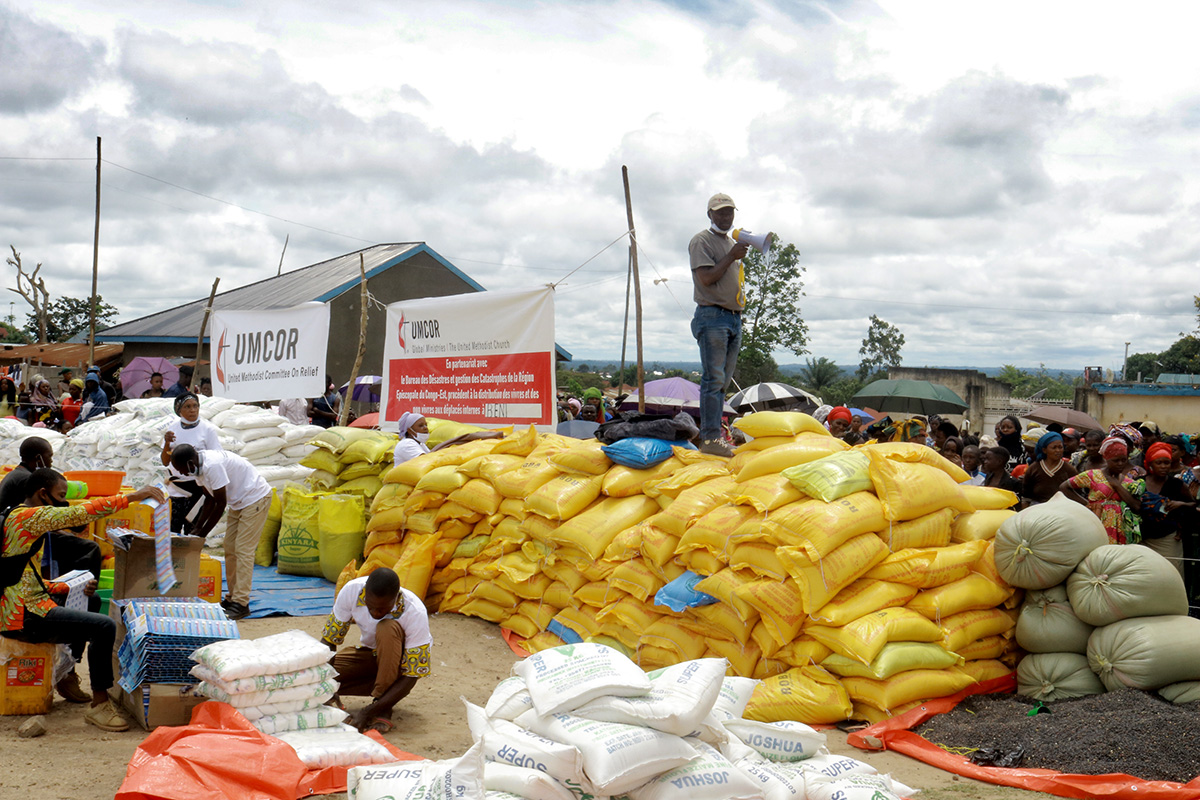 Jean Tshomba, coordinator of the United Methodist Committee on Relief's disaster management office in East Congo, explains to displaced people where the aid comes from and how it is distributed at Kalinda Stadium in the Mulekera commune in Beni, Congo. UMCOR provided almost $100,000 USD for food and other relief. Photo by Philippe Kituka Lolonga, UM News. Jean Tshomba, coordinator of the United Methodist Committee on Relief's disaster management office in East Congo, explains to displaced people where the aid comes from and how it is distributed at Kalinda Stadium in the Mulekera commune in Beni, Congo. UMCOR provided almost $100,000 USD for food and other relief. Photo by Philippe Kituka Lolonga, UM News.