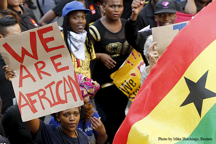 Demonstrators carry placards during a march against xenophobia in Johannesburg in 2015. Xenophobia — fear or hatred of strangers or foreigners — continues to be widespread in South Africa, where harassment and violence against African and Asian non-nationals are routine and sometimes lethal, according to Human Rights Watch. File photo by Mike Hutchings, Reuters.