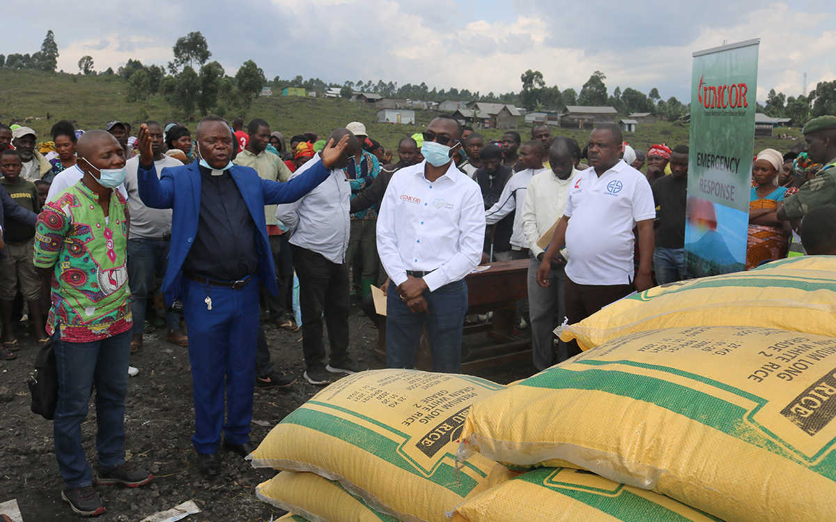 The Rev. Henry Jean Robert Kasongo Numbize prays over relief supplies in Goma, Congo, that will be provided to help survivors of the May 22 eruption of the Mount Nyiragongo volcano, about 10 miles from Goma. Numbize is superintendent of The United Methodist Church’s Goma District. Photo by Philippe Kituka Lolonga, UM News.