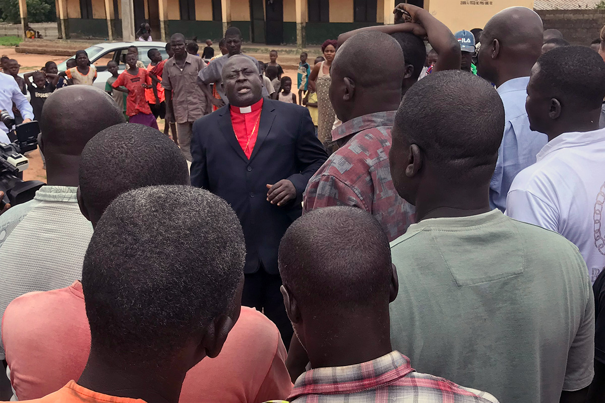Nigeria Area Bishop John Wesley Yohanna (center) speaks to people at a camp for internally displaced persons in Jalingo, Taraba State, Nigeria, in 2019. Conflict has intensified in the Nigeria Episcopal Area in recent months. Two aides to Yohanna reported several United Methodists to the police for allegedly disrupting the Nigerian United Methodist Church and training others to become “rude and aggressive” toward Yohanna, while opponents have accused the bishop of treating them unfairly and mismanaging projects — charges the bishop denies. File photo by Tim Tanton, UM News.