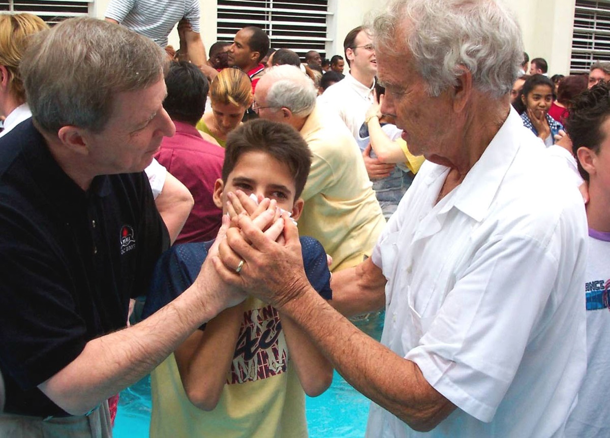 The Revs. H. Eddie Fox (right) and George Freeman join 50 other Wesleyan/Methodist clergy and bishops from throughout the Americas at a mass baptism of more than 200 adults and children in Havana in 2004. File photo by Roy Corbin.