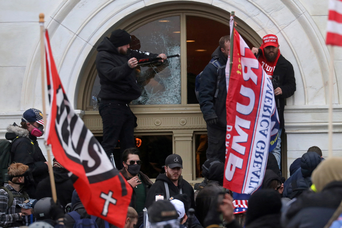 A man breaks a window as supporters of U.S. President Donald Trump storm the U.S. Capitol building in Washington on Jan. 6, 2021. Discipleship Ministries is offering a new Courageous Conversations resource to help United Methodists talk about Christian nationalism in a respectful way. REUTERS/Leah Millis.  A man breaks a window as supporters of U.S. President Donald Trump storm the U.S. Capitol building in Washington on Jan. 6, 2021. Discipleship Ministries is offering a new Courageous Conversations resource to help United Methodists talk about Christian nationalism in a respectful way. REUTERS/Leah Millis.