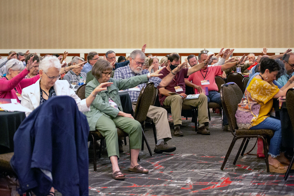 Northwest Texas Conference voters pray for the conference’s 14-member transition team appointed by Bishop W. Earl Bledsoe to educate voters about their options under a proposed plan of denominational separation heading to the coming General Conference. During the Aug. 13-14 Northwest Texas Annual Conference meeting in Lubbock, Texas, voters signaled their hope for the conference to move to a new denomination under the plan. Photo courtesy of the Northwest Texas Conference. 