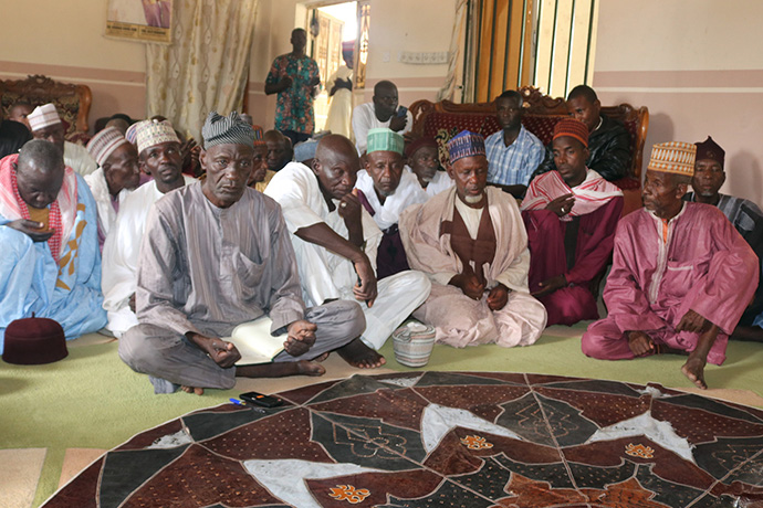 Community leaders in Karim Lamido, Nigeria, gather to discuss peace and reconciliation efforts following episodes of violence in the area. United Methodist Bishop John Wesley Yohanna, who organized the meeting, called on those attending to pray for peace. Photo by Ramson Danjuma, UM News.