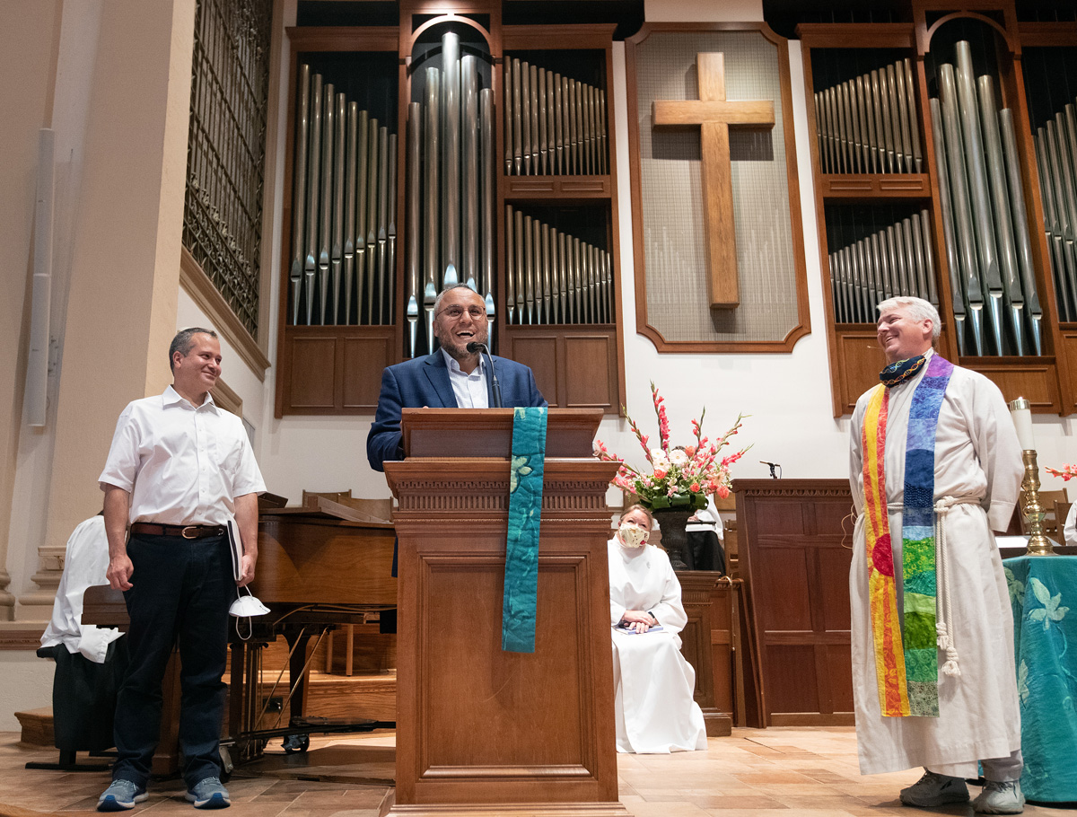 Imam Ossama Bahloul of the Islamic Center of Nashville expresses appreciation to Belmont United Methodist Church in Nashville for hosting his congregation during Friday prayers in the month of Ramadan while their mosque was being renovated. At left is Kamel Daouk, board chairman of the Islamic center. At right is the Rev. Paul Purdue, senior pastor at Belmont. As the U.S. marks the 20th anniversary of the Sept. 11, 2001, terrorist attacks, one expert in Islamic-Christian relations said perceptions of Islam by Americans have improved over the past two decades. Photo by Mike DuBose, UM News. 