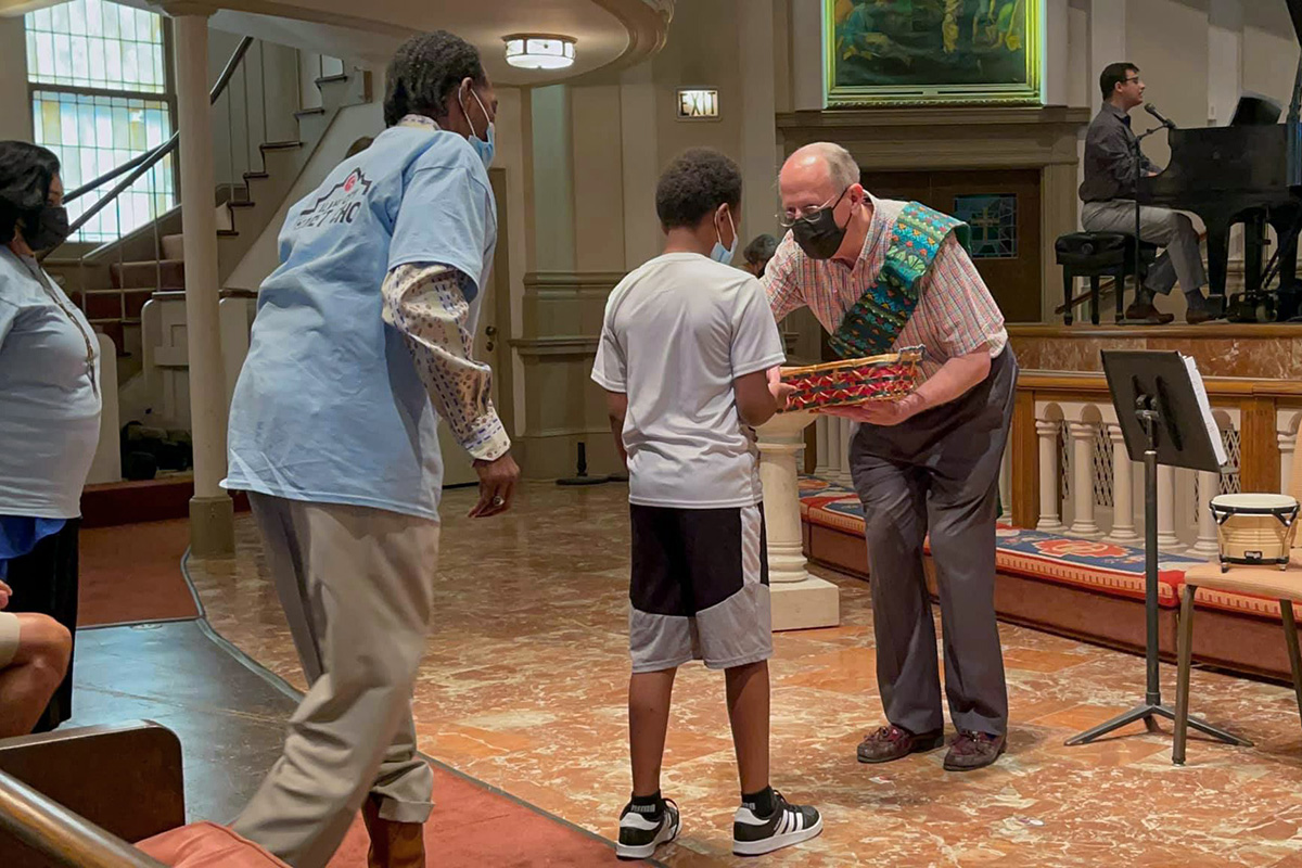 The Rev. Taylor Boone serves communion during a July 11 service at Travis Park (United Methodist) Church in San Antonio. Boone, a lawyer as well as minister, died on Sept. 15, prompting an outpouring of appreciation for his ministry with the homeless and his role in expanding United Methodist-related health care in South Texas. Photo courtesy of Travis Park Church.