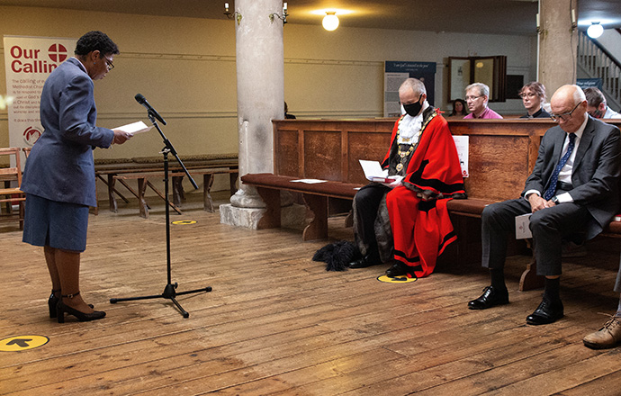 The Rev. Novette Headley prays with celebrants at the Sept. 12 service celebrating “The Asbury Crossing: Responding to Call.” Headley is superintendent minister of the Bristol & South Gloucestershire Methodist Circuit and a trustee of John Wesley’s New Room in Bristol, England, where the event was held. Photo by Tim Tanton, UM News.