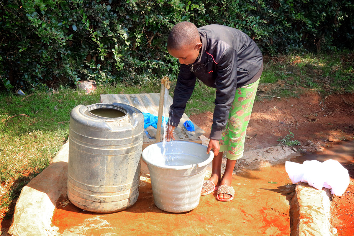 Josephine Kwamboka, 12, fetches water from a tap installed by First United Methodist Church of Moheto, Kenya. Prior to the installation of the well, children traveled great distances each day to find water in streams and ponds. Waterborne illnesses have decreased significantly since the well was drilled. Photo by Gad Maiga, UM News.