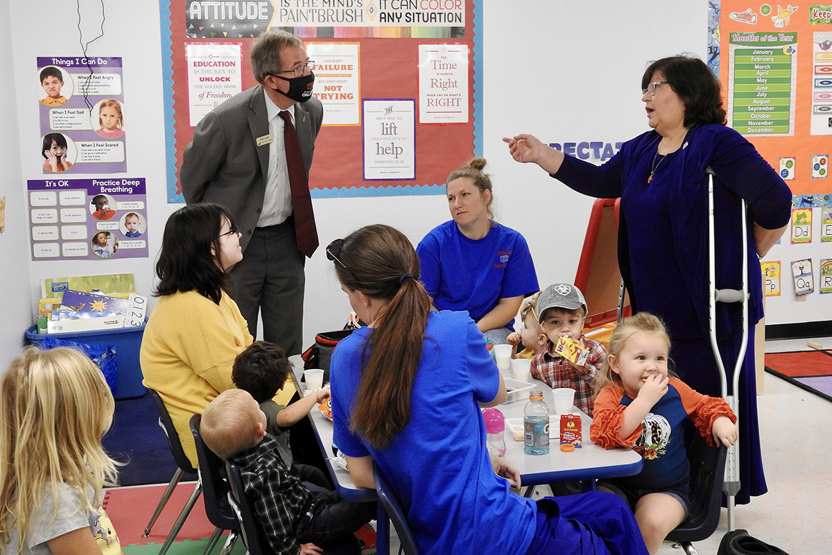 Texas Conference Bishop Scott Jones and the Rev. Jill Daniel (standing with Jones) visit with children and supervisors at the new Methodist Children’s Center in Linden, Texas. Jones has made child welfare a conference priority, and Daniel leads the conference’s effort to plant child care centers in underserved areas. Photo by Sam Hodges, UM News.