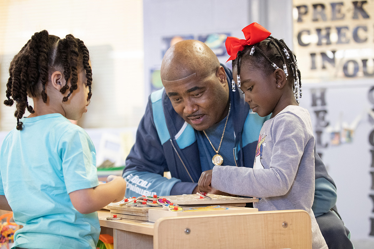 Steve Fleming visits with daycare students Malakhai (left) and Melody at Bethlehem Centers of Nashville (Tenn.) Fleming is the center’s chief executive officer. Photo by Mike DuBose, UM News.