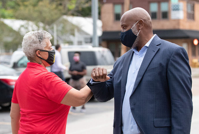 The Rev. Ed Jones (right) greets Houston City Council Member Carolyn Evans-Shabazz outside Trinity United Methodist Church in Houston where the church provided study space and supervision for students whose parents needed to return to work during the COVID-19 pandemic in 2020. File photo by Mike DuBose, UM News.