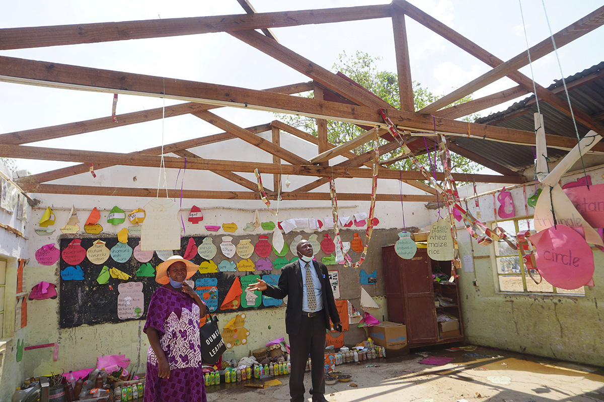 Nyorovai Masvanhise (left) and Tendai Madzukwa survey damage at the United Methodist Mashambanhaka Primary School, some 80 miles northeast of Harare, Zimbabwe, after a storm peeled the roof off of several classrooms. Masvanhise is the school’s development chair and Madzukwa is senior teacher at the primary school. Photo by Kudzai Chingwe, UM News.