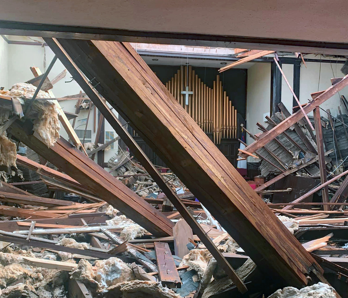 The sanctuary of Dresden First United Methodist Church in Dresden, Tenn., lies in rubble except for the organ pipes and a cross and several exterior walls. Church member Jarrett Snider went to the church after a massive storm system swept through the area on Dec. 10-11 and documented the damage to the building and grounds. Photo by Jarrett Snider via Facebook.