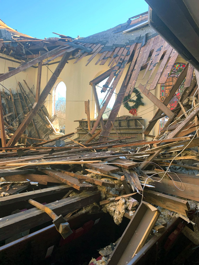 A Christmas wreath is visible amid the destruction at Dresden First United Methodist Church, in Dresden, Tenn. A tornado clobbered the sanctuary on the evening of Dec. 10. Photo by Jarrett Snider via Facebook.