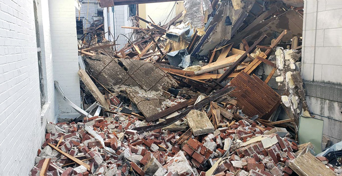 The massive amount of damage to Mayfield First United Methodist Church in Mayfield, Ky., makes it difficult to determine if the bricks and rubble have fallen between interior or exterior walls. Photo courtesy of Mayfield First United Methodist Church via Facebook.