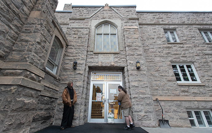 Nathaniel (left) and Frank wait for the day shelter to open at Trinity United Methodist Church in Idaho Falls. Photo by Mike DuBose, UM News.
