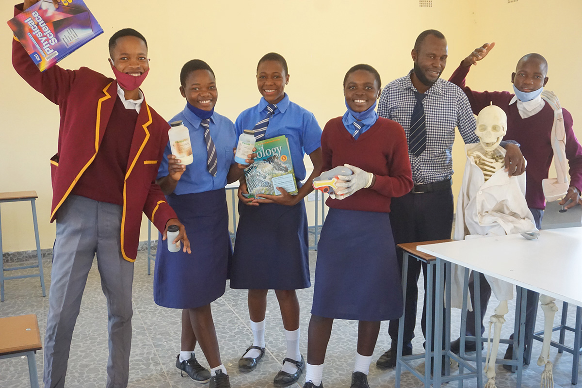 Science students and their teacher, Nyashirai Cletus Maruni, celebrate the installation of a new science laboratory at the United Methodist Hanwa Secondary School in Macheke, Zimbabwe. Funds for the laboratory were provided by Zimbabwe Volunteers in Mission. Photo by Kudzai Chingwe, UM News.