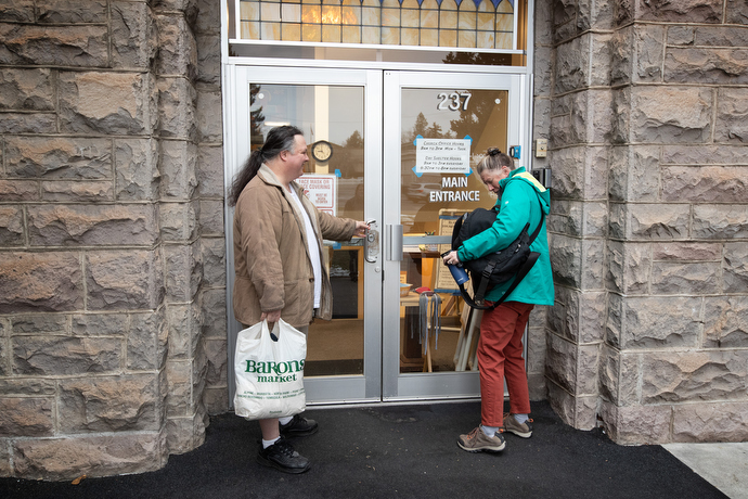 Frank (left) waits for the Rev. Ruth Marsh to open the day shelter at Trinity United Methodist Church. Photo by Mike DuBose, UM News.