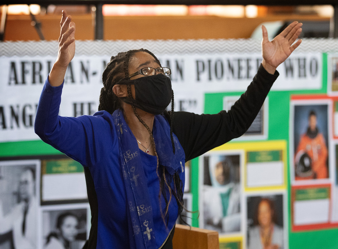 Angel Haynes lifts her arms in praise during worship Feb. 6 at John Wesley United Methodist Church in Nashville, Tenn. A survivor of a brain aneurysm, Haynes volunteers to help the homeless. Photo by Mike DuBose, UM News.
