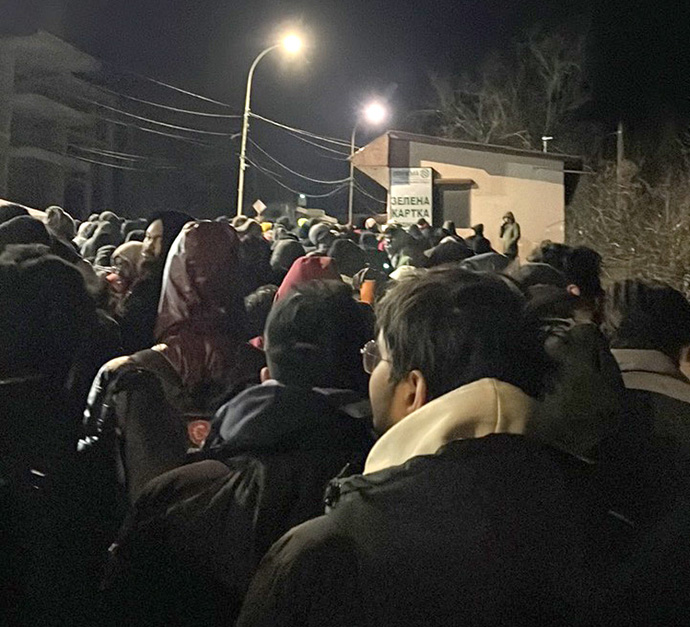 Refugees from Ukraine make their way into Slovakia from the Uzhhorod-Vyšné Nemecké border crossing in western Ukraine. A group of eight African students who had been studying in Kyiv, Ukraine, were met there by the Rev. Svetlana Komives Francisti from the United Methodist Church in Michalovce, Slovakia, who provided shelter for several of the students at her church. Photo courtesy of the Rev. John Calhoun.