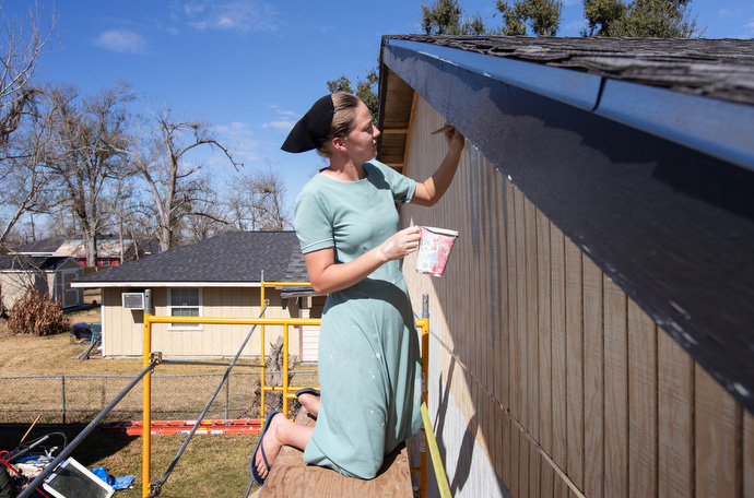 Hannah Yoder paints the wall of a home in Lake Charles. Yoder, a member of the Amish community in Ohio, was part of a volunteer team repairing homes in the area. Photo by Mike DuBose, UM News.