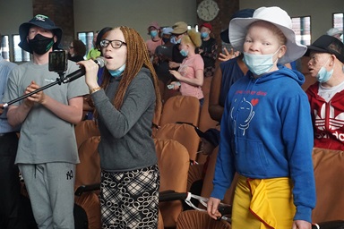 Tapiwanashe Nhunhama helps lead worship at Cranborne United Methodist Church in Harare, Zimbabwe, during a program to help support people living with albinism. The United Methodist Church’s Harare East District in partnership with the Johnstown District in the Western Pennsylvania Conference gave gifts of sunscreen, hats and food to people living with the condition. Photo by Kudzai Chingwe, UM News. Tapiwanashe Nhunhama helps lead worship at Cranborne United Methodist Church in Harare, Zimbabwe, during a program to help support people living with albinism. The United Methodist Church’s Harare East District in partnership with the Johnstown District in the Western Pennsylvania Conference gave gifts of sunscreen, hats and food to people living with the condition. Photo by Kudzai Chingwe, UM News.