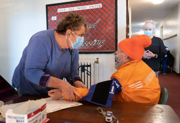 Debbie Pickett, RN, checks Timothy Wiscombe’s blood pressure during the free weekly medical clinic at Magnolia Avenue United Methodist Church. Photo by Mike DuBose, UM News.