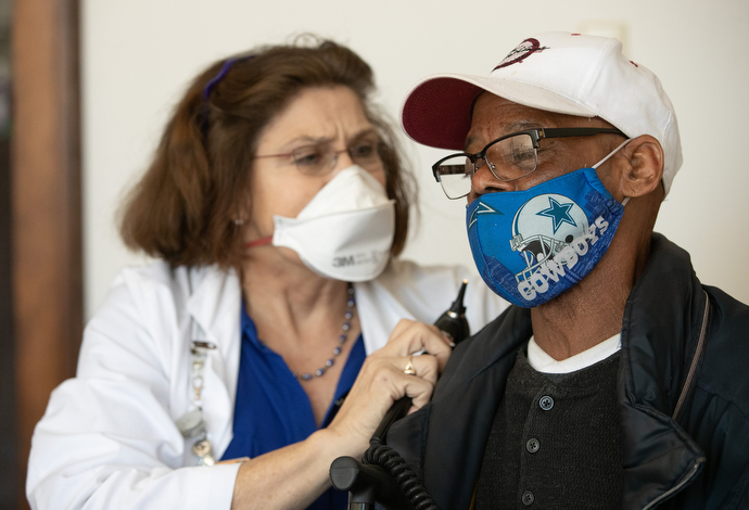 Dr. Janet Purkey prepares to examine Louis Peake’s ears during the weekly free medical clinic at Magnolia Avenue United Methodist Church. Purkey is cofounder of the clinic and a professor at the University of Tennessee, Knoxville. Photo by Mike DuBose, UM News.