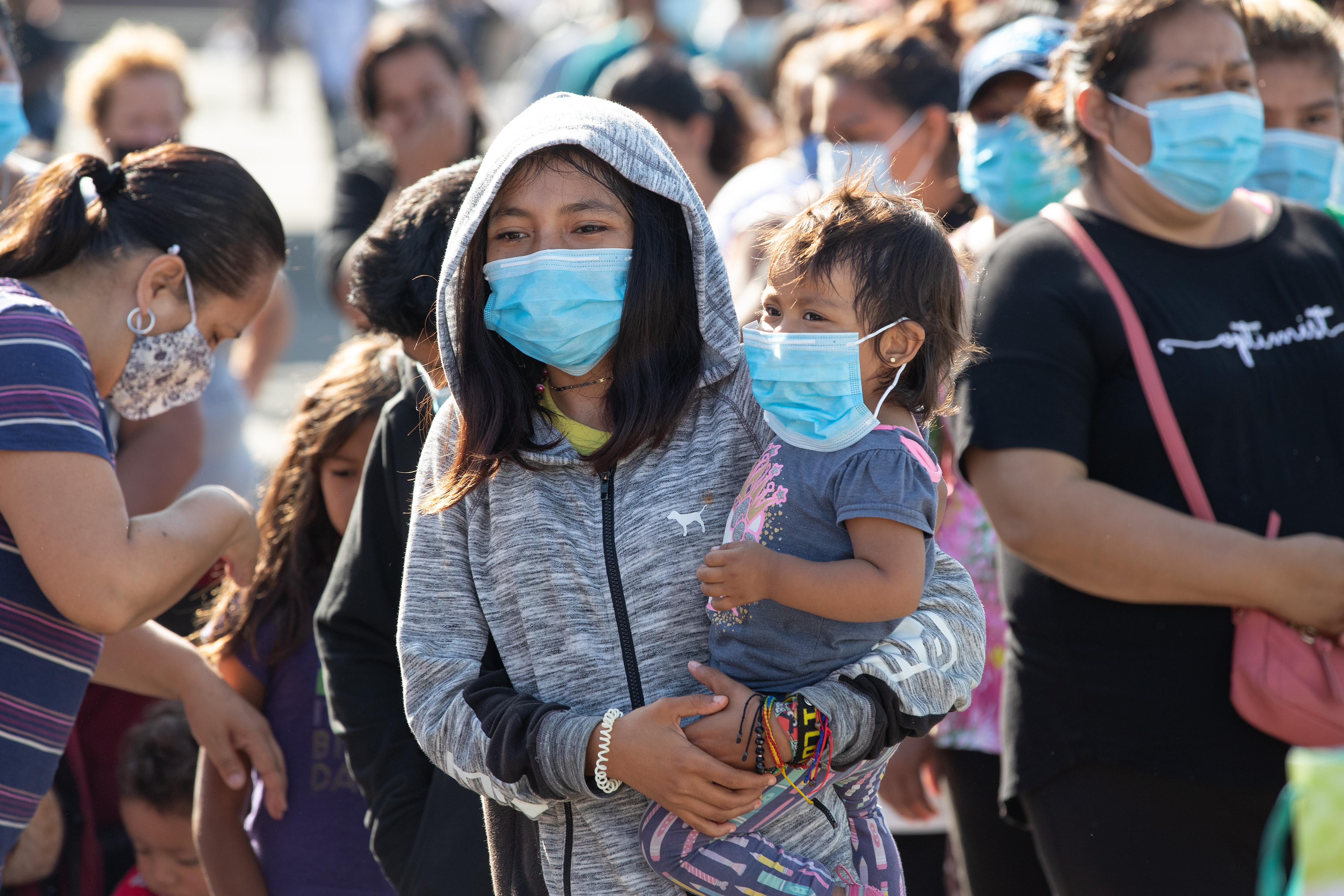 Migrants at a makeshift camp near the border crossing in Tijuana, Mexico, receive food and other relief supplies from the New Covenant Methodist Church and San Pablo Evangelical Church in Tijuana. Some 1,500 immigrants settled there, many of them hoping to file asylum claims with U.S. immigration authorities. Photo by Mike DuBose, UM News.