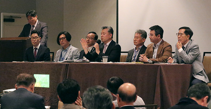 The Rev. Keihwan Kevin Ryoo (holding microphone) answers questions during a panel discussion about the state of The United Methodist Church and the future of the Korean church at the Association of Korean Churches in The United Methodist Church meeting in Dallas. Participating in the discussion, from left, are: the Rev. Ilyoung Will Kim, Rev. Yontaek Bae, lay elder Jinho Woo, Rev. Hanseung Koh, Ryoo, lay elder Jungkwan Choi, Rev. Sun Hyung Jo, and lay elder Kwanho Choi. Photo by the Rev. Thomas Kim, UM News.