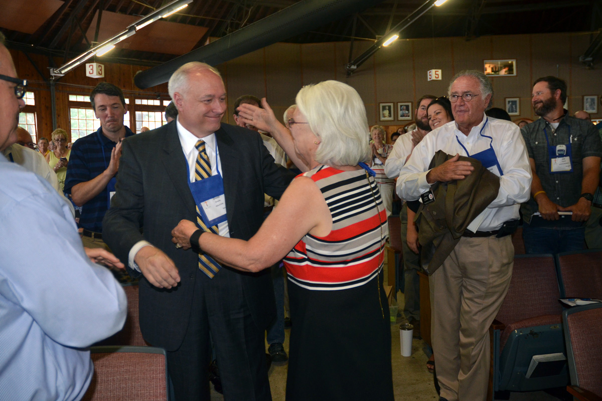 The Holston Conference’s Bishop Mary Virginia Taylor embraces the Rev. David Graves following his election as United Methodist bishop at the 2016 Southeastern Jurisdictional Conference. Taylor is among the 11 U.S. bishops who retired last year, and Graves is among the bishops now taking on extra work because of the retirements. The Judicial Council issued a decision May 20, addressing the question of whether jurisdictional conference can meet to elect new bishops. File photo by Annette Spence, Holston Conference.