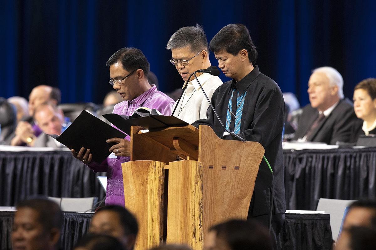 Filipino Bishops (from left) Rodolfo A. Juan, Ciriaco Q. Francisco and Pedro M. Torio Jr. lead prayer during the 2019 Special Session of the United Methodist General Conference in St. Louis. The Philippines Central Conference will convene for a special session on Nov. 24-26 to elect new bishops. The three current bishops are set to retire. File photo by Kathleen Barry, UM News.