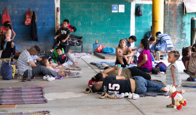 Families rest in the covered patio area of the Bethlehem Diocesan shelter in Tapachula, Mexico. Photo by Mike DuBose, UM News.